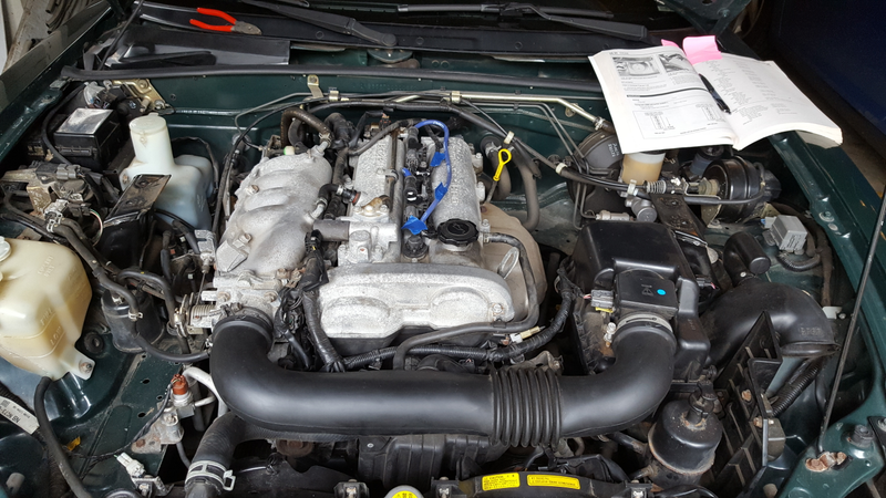 Old, dirty valve cover with everything labeled prior to disassembly.